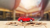 Fototapeta Mapy - Golden coins and toy car on  background