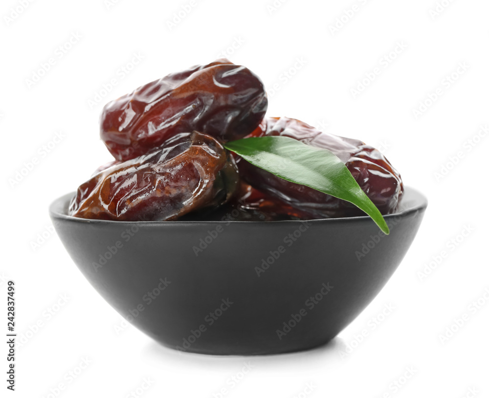 Bowl with sweet dried dates on white background