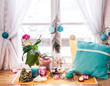 Feng Shui altar at home in living room or bed room. Attracting wealth and prosperity concept. Crystal clusters, wire tree with gemstones, golden Buddah figure on table and window sill. Vibrant colors.