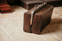 Leather Case Rests On Ceramic Tile On Floor