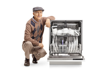 Sticker - Senior man kneeling next to a loaded dishwasher