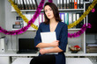 © Вячеслав Чичаев - Concept girl sitting in the office on the background of a closet with folders and working. she is in the middle of the frame and sits at the table on a chair. The girl works with documents.
