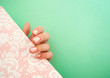 © Katerina - Young woman's hand with beautiful manicure on pastel pink and turquoise background with copyspace.