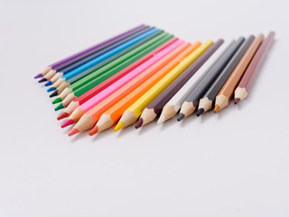 Wall Mural - colored pencils sharpened on a white background.