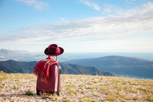 Suitcase With Felt Burgundy Hat And Plaid Scarf In Autumn Mountains. Concept Of Travel, Vacation, Trip, Adventure, Solo Female Tourism. Nature Background Of Amazing Landscape With Blue Sky And Sea.