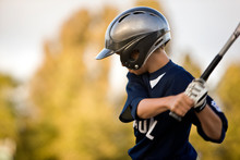 Young Baseball Player Prepares To Take A Swing.