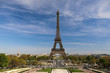 © kazanovskyiphoto - Eiffel Tower and there are a lot of tourists, cars and trees near it