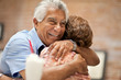 © Erickson Stock - Smiling senior man happily embracing his wife.