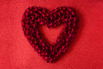 Heart made of red roses on red bright background for Valentine's Day

