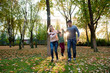 © nagaets - Family of three enjoy autumn park having fun smile
