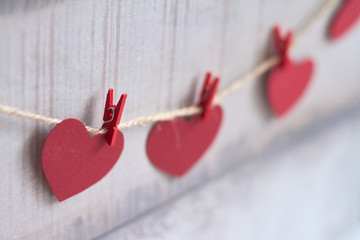 Red hearts on wooden background.Valentines day greeting card.