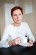 © Evgeny Leontiev - Woman drinking coffee in the morning, at the table