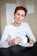 © Evgeny Leontiev - Woman drinking coffee in the morning, at the table