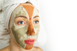 Beauty procedures skin care concept. Multi-masking - woman with two different color mud clay masks on her face targeting various face problem areas 