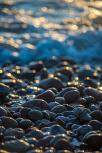Abstract Details Of Rocky Beach Pebbles In Sunset By The Sea