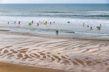 Unrecognisable surfers in the water on the Atlantic coast of France near Lacanau-Ocean, Bordeaux, France