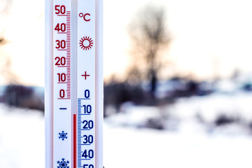 thermometer shows 10 degrees of frost. thermometer in the background of the winter landscape. weathe