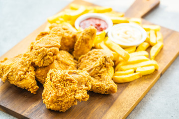 Wall Mural - Fried chicken wings with french fries and tomato or ketchup and mayonnaise sauce