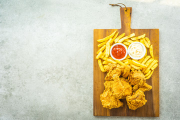 Wall Mural - Fried chicken wings with french fries and tomato or ketchup and mayonnaise sauce