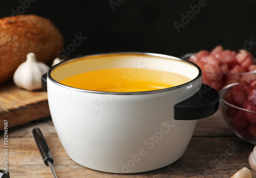 Fotografie, Obraz Pot with hot oil for meat fondue on table