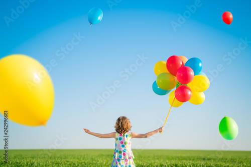 Happy child playing outdoors in spring field
