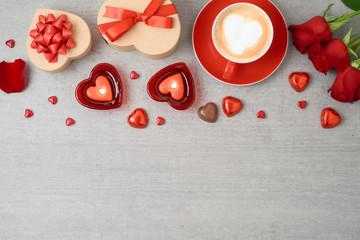 Wall Mural - Valentine's day background with coffee cup, heart shape chocolate, candles and gift boxes.