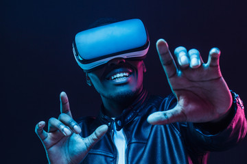 African man wearing virtual reality headset having great fun