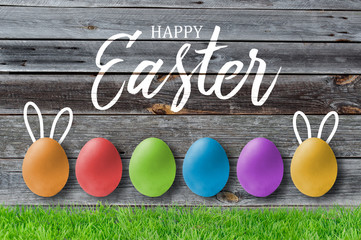 Happy easter greeting card on wooden background