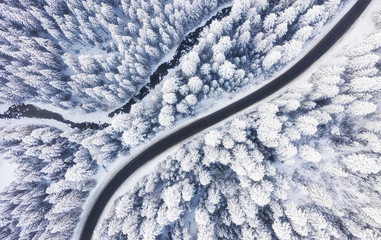 Wall Mural - aerial view on the road and forest at the winter time. natural winter landscape from air. forest und