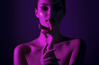 © Mirrorstudio - Young beautiful girl with magenta neon lighting