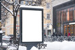 © Alex - Vertical mock-up of city poster winter city with thick edges, blank white billboard in urban settings, empty street information placeholder on sidewalk with copy space for logo