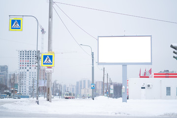 Outdoor advertising mockup billboard. on the street of a winter city under the snow.