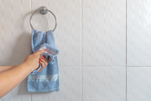 Woman drying hands with towel