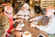 © Seventyfour - Group of happy senior friends in casual clothing gathering together in cafe to discuss last news and drink tea