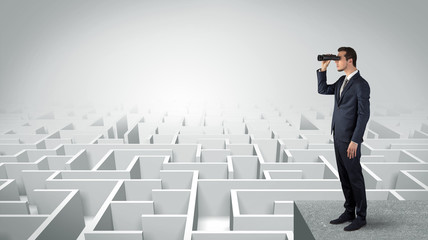 Wall Mural - businessman standing on maze and looking forward to the future concept