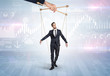 © ra2 studio - Puppet businessman controlled by another hand with financial concept