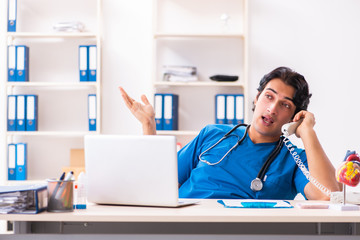 Young handsome doctor working at the clinic 