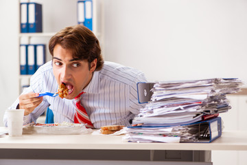 Wall Mural - Man having meal at work during break