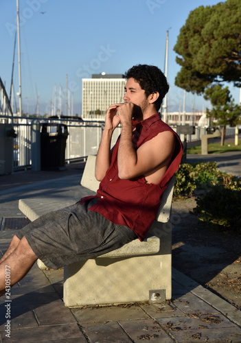 Fotografie, Obraz Handsome young man playing the harmonica