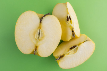 Canvas Print - Apple slices on a green background.