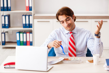 Wall Mural - Man having meal at work during break