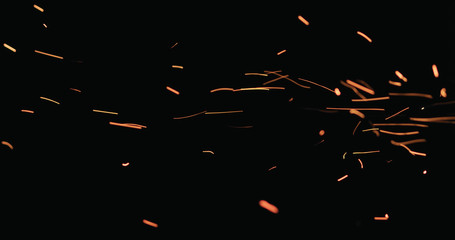 hot sparks floating from side on black background