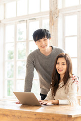 Canvas Print - young asian couple relaxing in living room