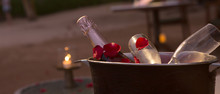 Valentine's Day, Romantic Dinner Or Date With Champagne And Two Glasses, Candles And Rose Petals