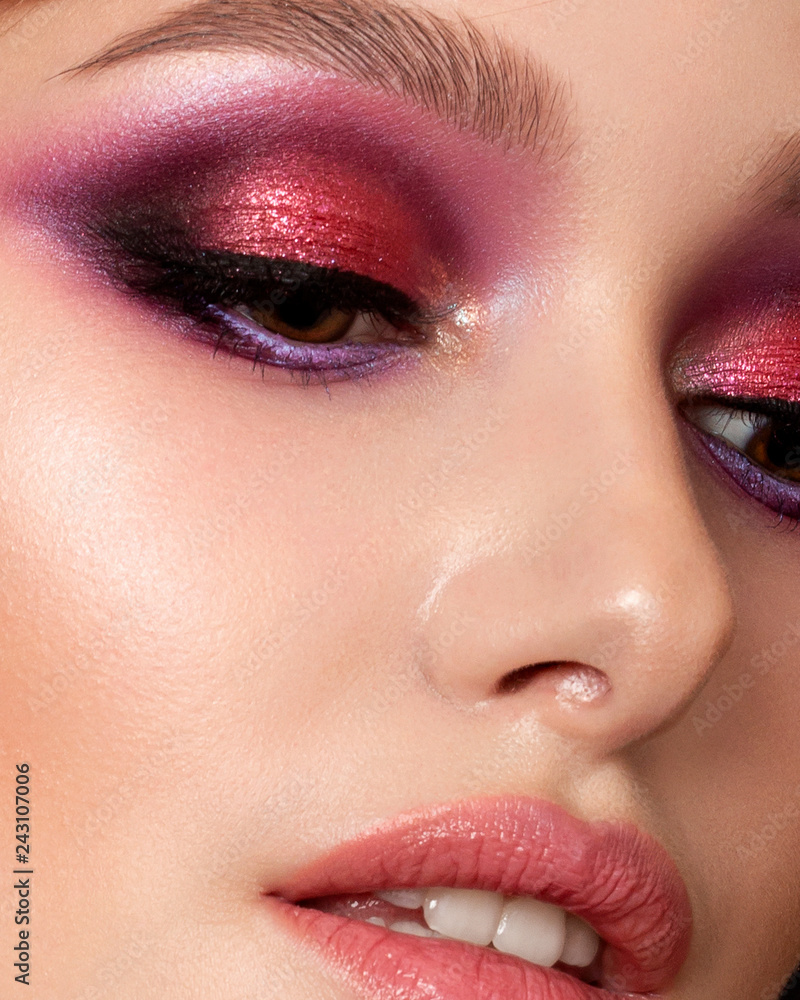Closeup portrait of young beautiful woman with bright pink smokey eyes and lips. Fashion makeup. Studio shot. Modern summer make up. Extreme closeup, partial face view - obrazy, fototapety, plakaty 