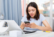 © JackF - Young  girl student using laptop and phone at the home