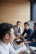 © alfa27 - Positive young multiracial male team sitting at conference meeting table listening to speaker presenting new project in office, Business Team Meeting Brainstorming Togetherness Concept.
