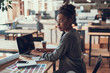 © Yakobchuk Olena - Charming afro american girl using laptop at workplace
