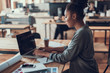 © Yakobchuk Olena - Charming afro american girl in glasses using laptop at work