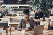 © Yakobchuk Olena - Beautiful afro american girl using smartphone at modern office